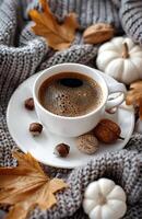 Cup of Coffee With Autumnal Decorations on a Knitted Blanket photo