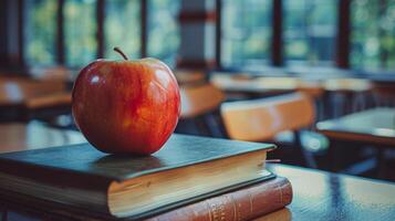 Red Apple on Top of Books in Empty Classroom photo