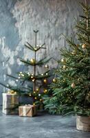 Decorated Christmas Tree With Lights and Ornaments Near Small Tree in Front of Gray Wall photo