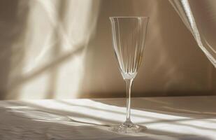 Empty Champagne Flute on White Fabric With Light Streaks photo