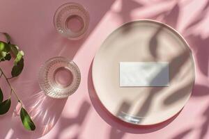 White Card Mockup With Glass of Water on Pink Background With Sunlight photo