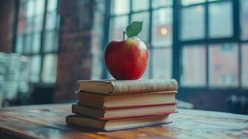 A Red Apple Rests Atop Two Books In A Library Setting photo