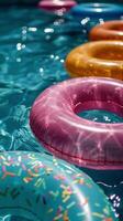 Colorful Inflatable Rings Floating in a Pool on a Sunny Day photo