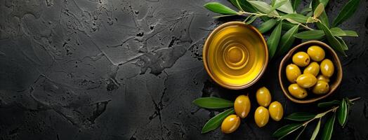 Fresh Olive Branch and Oil on Dark Textured Background photo