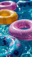 Colorful Inflatable Rings Floating in a Pool on a Sunny Day photo