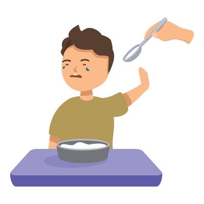 Little boy refusing to eat soup sitting at the kitchen table crying