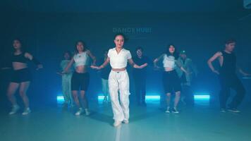 Group dance performance in a studio with blue lighting video