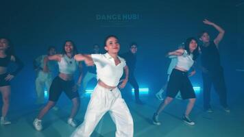 Group dance performance in studio with blue lighting video