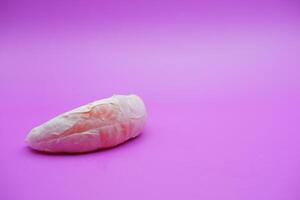 a slice of grapefruit isolated on a purple background. peeled grapefruit photo