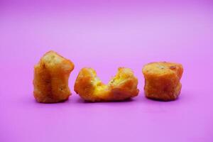 3 fried bananas isolated on purple background photo