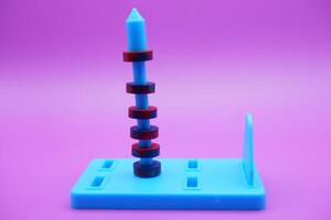 Circle magnets arranged in a pile isolated on a purple background photo