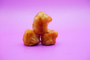 3 fried bananas isolated on purple background photo