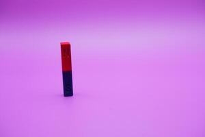 bar magnet isolated on purple background photo