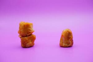 3 fried bananas isolated on purple background photo
