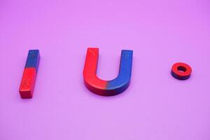 various shapes of magnets isolated on a purple background photo