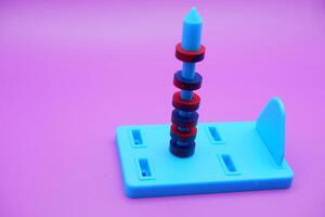 Circle magnets arranged in a pile isolated on a purple background photo