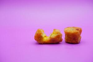fried banana isolated on purple background. mini fried bananas photo