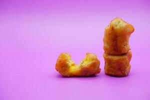 3 fried bananas isolated on purple background photo