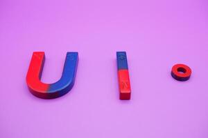 various shapes of magnets isolated on a purple background photo
