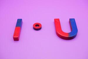 various shapes of magnets isolated on a purple background photo