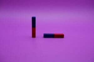 two bar magnets isolated on a purple background photo