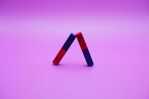 two bar magnets isolated on a purple background photo