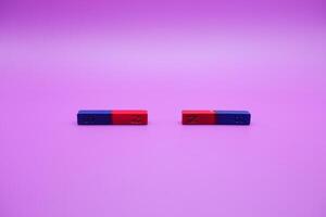 two bar magnets isolated on a purple background photo