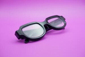 sunglasses isolated on purple background. sunglasses with curved frames and transparent glass. photo