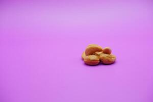 cashew nuts isolated on a purple background photo