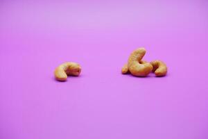 cashew nuts isolated on a purple background photo