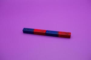 two bar magnets isolated on a purple background photo