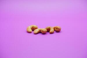 cashew nuts isolated on a purple background photo