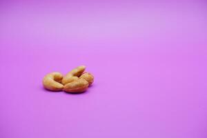 cashew nuts isolated on a purple background photo