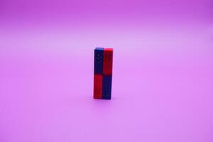 two bar magnets isolated on a purple background photo
