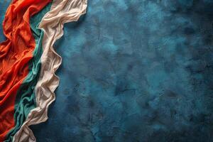 Orange, Teal, and White Fabric Draped on Blue Background photo