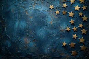 Golden Stars Scattered on Dark Blue Textured Background photo