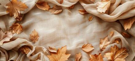 Dried Autumn Leaves Frame Brown Burlap Fabric Background photo