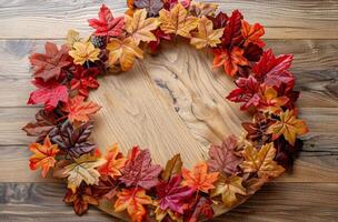 Colorful Autumn Leaves and Berries Framing a Wooden Background photo