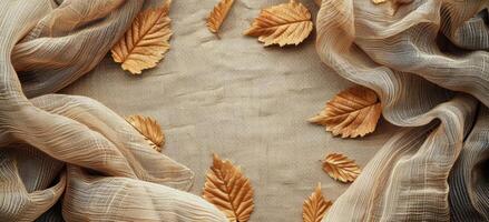 Dried Autumn Leaves Frame Brown Burlap Fabric Background photo