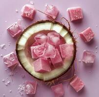 Pink Coconut Ice Cubes on Lavender Background photo