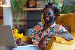 Smiling Man Using Laptop in Yellow Chair photo