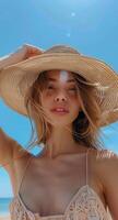Woman Wearing Straw Hat on Beach in the Summertime photo