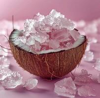 Crushed Ice In A Coconut Shell On Pink Background photo