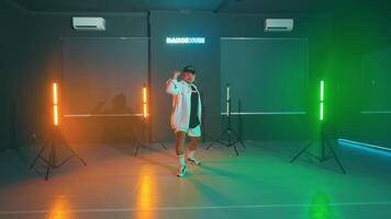 Energetic dancer in a colorful studio video