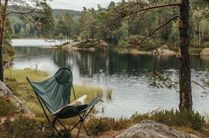A Relaxing Camping Chair by the Lake on a Foggy Morning photo