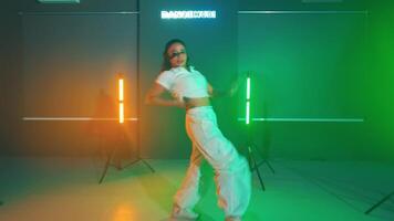 Dancer in a modern studio with colorful lighting video