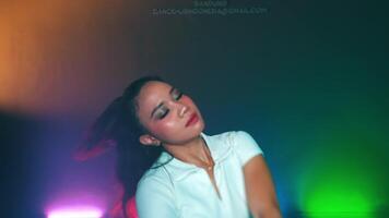 Woman dancing in a studio with colorful lights video