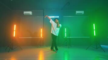 Energetic dance performance in a colorful studio video