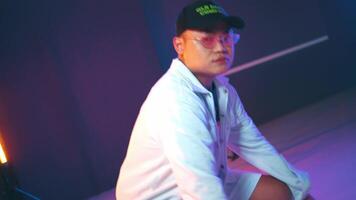 Man in white jacket with neon lights background video