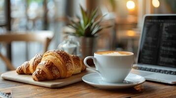 Freshly Baked Croissant and Cappuccino on a Sunny Morning Table photo